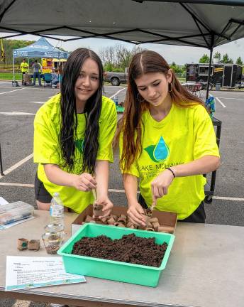 Photos: Earth Day Fair Delaney Wells and Antalya Demir prepare seed planters.