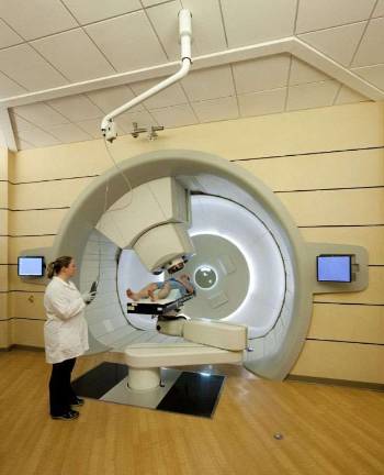 Four years cancer-free from proton therapy The proton gantry and a patient undergoing treatment