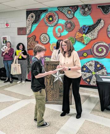 Wallkill Valley Regional High School art teacher Amy Fairweather presents a first-place prize to senior Georgia Wheeler for her artwork in the Mixed Media category. (Photos provided)