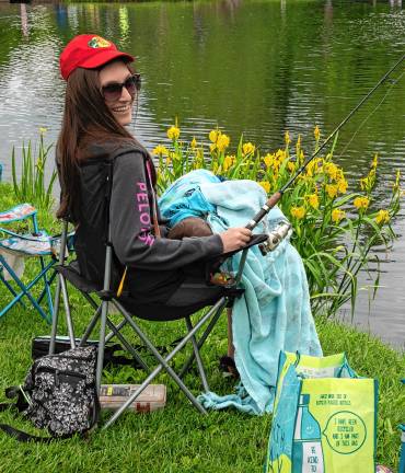 Photos: Annual Trout Derby in Sparta Nicole Charpentier and John Byar, who is hiding on her lap.
