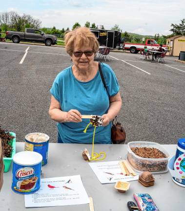 Photos: Earth Day Fair Millie Lipkin makes a pine cone bird feeder.