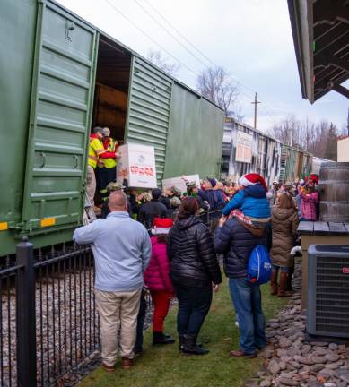 Donated toys are loaded aboard the train.