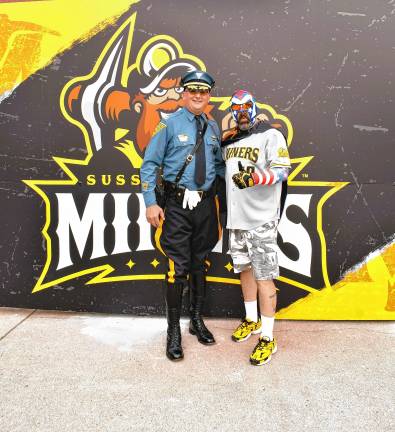 Photos: Battle of the Badges III <b>New Jersey State Police Capt. A. Jones poses with a Miners fan.</b>
