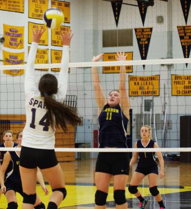 Sparta gets first volleyball win Sparta's Emily Lake strikes the ball as Vernon's Julia Dehnert (11) leaps to challenge.