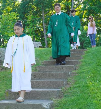 Ogdensburg eighth graders progress to Pomp and Circumstance, with Councilwoman Brenda O'Dell helping on right. (Photo by Vera Olinski)