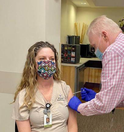 Hewitt, N.J. resident Krissy Maxwell, a mammography technologist for Holy Name Medical Center, gets vaccinated.