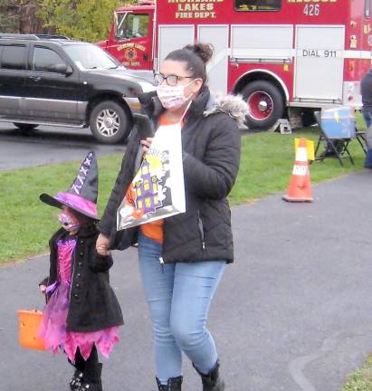 A little witch walks the trail to get some goodies (Photo by Janet Redyke)