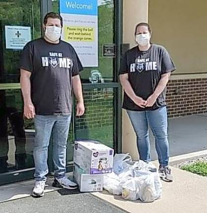 Brother and sister team Karen and Rob Carney dropping off supplies at Project Self-Sufficiency, which assists low-income families (Photo provided)