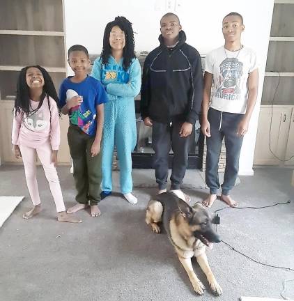 After a long and costly wait, the Polhills are finally home The Polhill children (from left): Eva, 8; Miles, 9; Imani, 13; Noah, 14; and Ray Jr.; 16; with Ceasar (Photo by Naeemah Polhill)