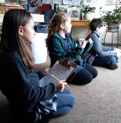 Students record data that will be sent to Cornell Lab of Ornithology for further research.