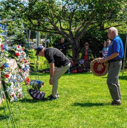 Photos: Memorial Day Parade Members of the Knight of Columbus place a wreath.