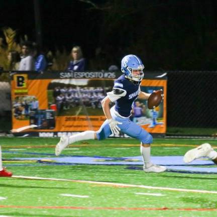 Brendan Cina carries the ball into the endzone for a touchdown.