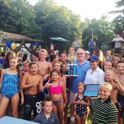 Lake Mohawk Pool owner Greg Leo surrounded by swim team members after a tournament win in 2016 Photo by Rose Sgarlato