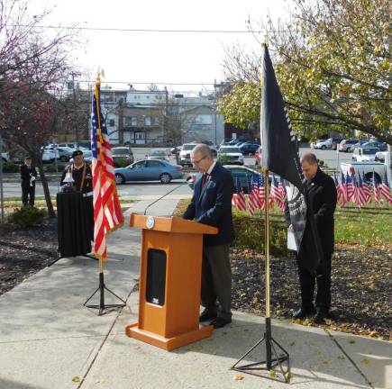 Flags of Newton Deacon Tom Zayac of St. Joseph’s RC Church delivers the invocation at the Newton Flags of Honor ceremony on Saturday, Nov 9, 2019 at the municipal building. Listening are (L-R at rear) Korean War Veterans of America Bugler Michael Delvecchio, American Legion Lt. Charles A. Meyer Post 86 Honor Guard member Antonio Delgado and Newton Town Manager Tom Russo.