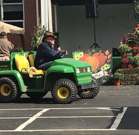 Roy Knutsen, one of the Fall Fest's co-directors, helps coordinate the days events from his tractor.