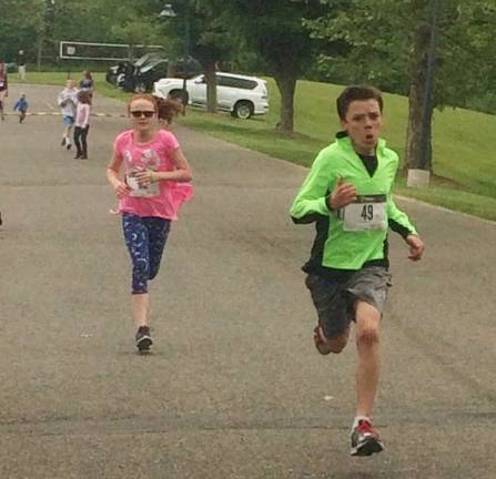 The thrilling finish of The Stampede Mile, on Saturday, saw a race to the finish between Brenna Philson and Patrick Payne. Both live in the area and are members of The Bears Youth Running Program, which helped host the event.