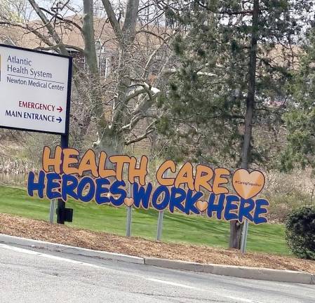 Signs in front of Newton Medical Center thank healthcare heroes