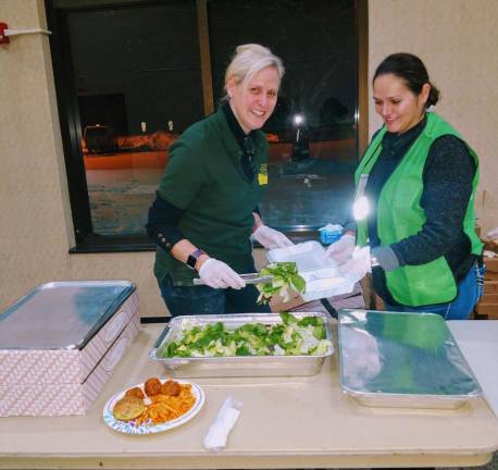 Unpacking the food to be served to community members in the aftermath of the storm.