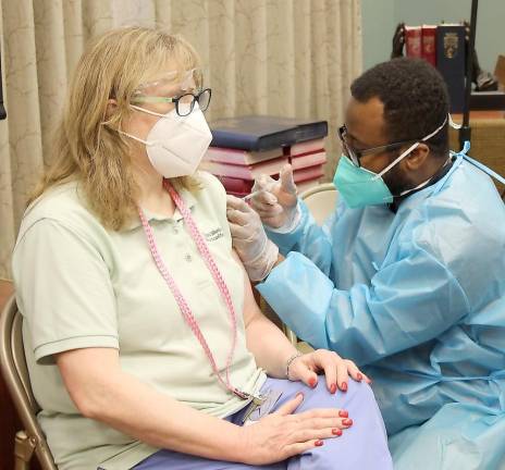 An associate at United Methodist Communities at Bristol Glen receives her first Covid vaccine during a clinic set up by CVS Pharmacy staff. The second shot is tentatively scheduled for Jan. 23 (Photo by Jeffrey Lisk)