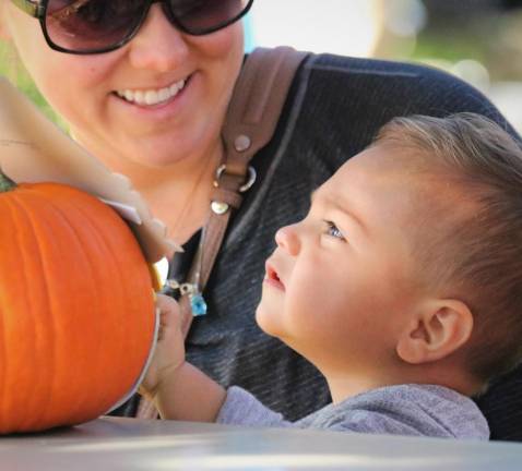 Dominic Blacco, 15 months, gazes at the Halloween pumpkin with his mommy.