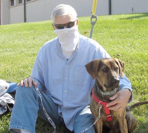 John Fedynich and Bentley wait for their turn to receive a St. Francis of Assisi feast day blessing. (Photo by Janet Redyke)