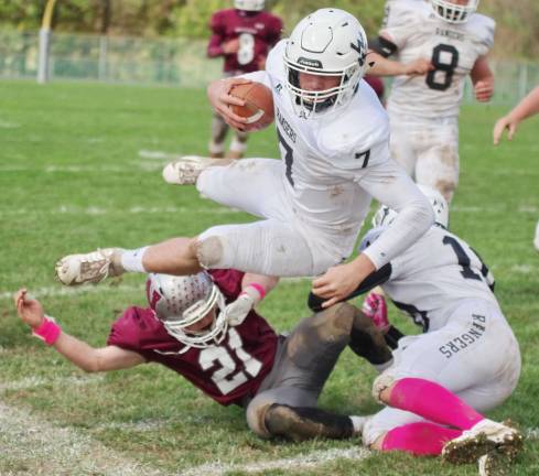 Wallkill Valley quarterback Alex Mastroianni leaps over a Newton defender and out of bounds after a long gain in the second half. Mastroianni threw for 110 yards and 1 touchdown.