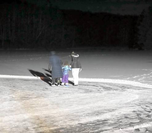 Residents ice skate on Heater's Pond (Photo by Vera Olinski)