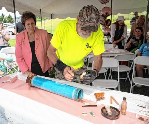 Photos: 80th birthday party Marjorie Strohsahl, a co-founder of the Sparta Historical Society, watches Ron Constable remove items from a time capsule at a party to celebrate her 80th birthday. The time capsule had materials from a Girl Scout troop who camped at Camp Sacajawea in 1969. (Photos by Nancy Madacsi)