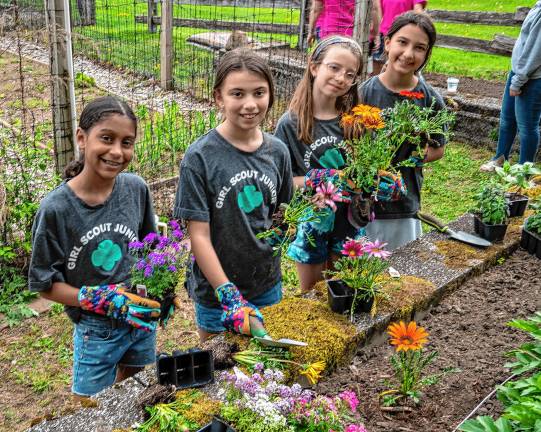 Photos: Earth Day Fair Girl Scouts Cataleya Azona, Brianna Davis, Amelia Towe and Abigail Corbisiero plant flowers in the community garden during the Earth Day Fair on Saturday, May 3 at Sparta Middle School.