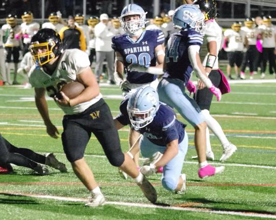 Highlanders rout Spartans, 31-0 West Milford ball carrier Jeffrey Papienuk crosses the goal line for a touchdown in the first half. Papienuk scored three rushing touchdowns in the game.