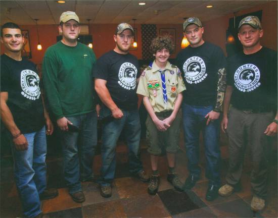 Scout completes project for Wounded Warriors Delaney is pictured with members of the Wounded Warriors.