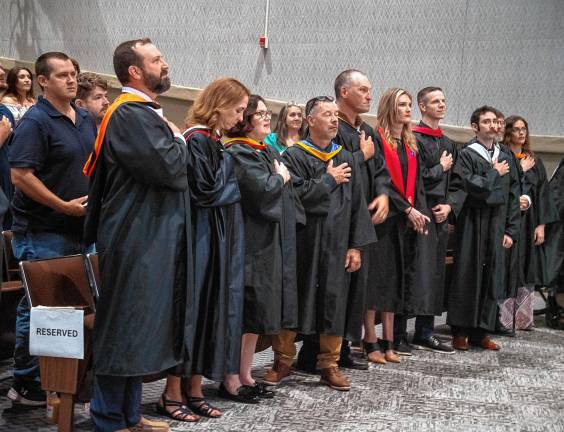 Photos: Sussex County Technical School graduation Faculty members recite the Pledge of Allegiance.