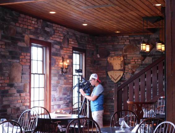 Restaurant Hunter tapes an episode at Mohawk House A videographer for Restaurant Hunter balances lighting at the Mohawk House prior to the taping of a segment that will air in September on FIOS 1.