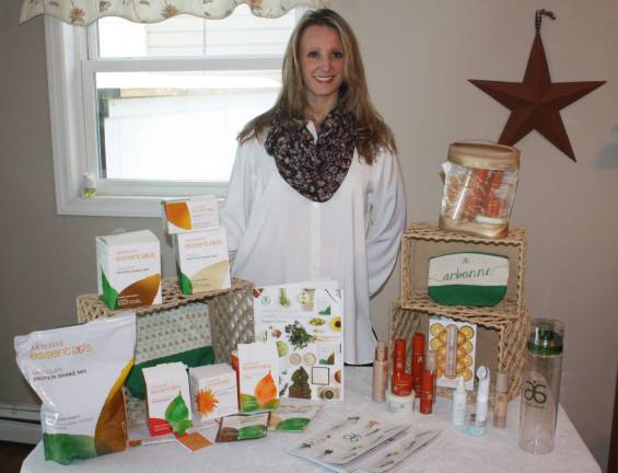 Passion for her products drives Van Hook's business Tracie Van Hook displays some of the Arbonne products that she sells.