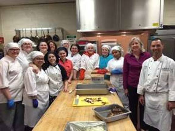 Tech chefs cook for real estate agents Tech school chefs get together with Coldwell Banker agents.