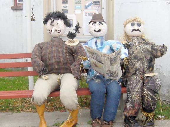 These dashing pumpkin heads await your visit Branchville’s Johnny’s Barber Shop displays three barber shop patrons (Photo by Janet Redyke)