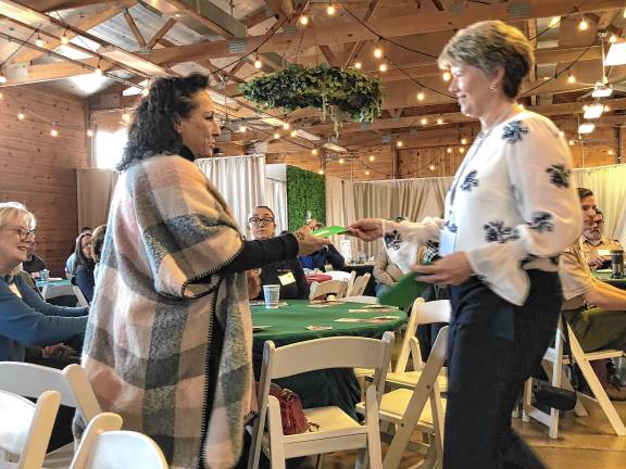 Community food pantry turns 40 FP1 Susan Foy, right, vice president of the German Christmas Market of New Jersey, presents a check to Valerie Macchio, executive director of the Sparta Community Food Pantry. (File photo by Kathy Shwiff)