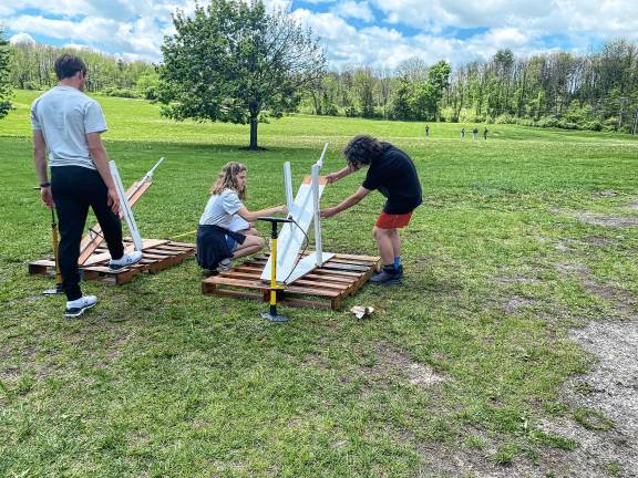 Students build water rockets ST1 Hardyston Middle School competitors and high school assistants, from left, Noah DeRenzo, Emily Guarino and Jovanni Portilla prepare their launcher for final testing during the annual STEM League Challenge on May 7. (Photos by Juleanna Green)