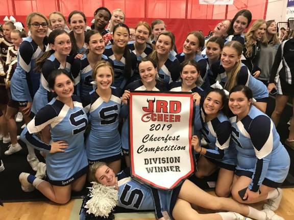 Sparta Cheer Sparta Cheer Team holds its banner proudly: JRD Cheer 2019 Cheerfest Competition Division Winner.