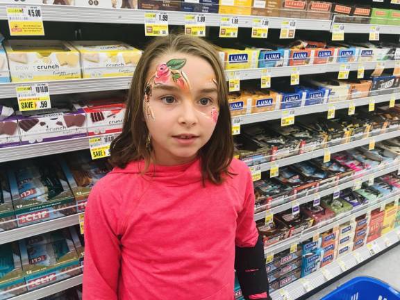 An adorable Sparta 3rd-grander says the face painting of a spider and rose were just perfect for a grand opening so close to Halloween.