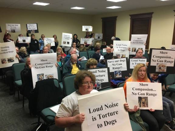 Roomful of protesters hold signs against police shooting range at Hopatcong Town Council meeting Photos by Amy Shewchuk