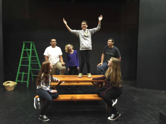 Canterbury Tales come to life on stage Photos provided Haley Lang (on table) as the Cook prepares to tell the next tale as (from left to right) Olivia Weintraub, Terrell Cannon, Annalyse Svendsen, Alejandro De Los Santos and Hannah Billing look on.)