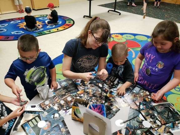 May the 4th Be with You Devore Family: (From left to right) Strider, Julia (mom), Brody, and Ella create buttons with images of their favorite Star Wars characters.