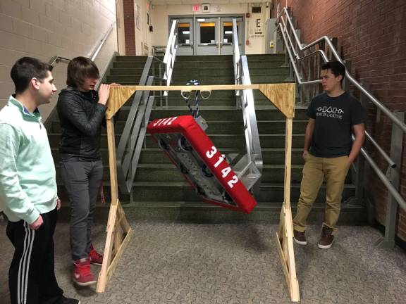 High school robotics teams 'turn gears' for competition Newton and Vernon represent Sussex County Newton High School robotics team students testing the climbing mechanism on their robot Photo by Liam Oakes