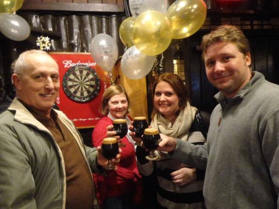Krogh’s brewery celebrates 15 years with cave-aged brew Jeff and Diane Little, of Newton, and Kerstin and Matt Martinka, of Hampton, each enjoy a glass of Krogh's 15th anniversary Russian imperial stout.