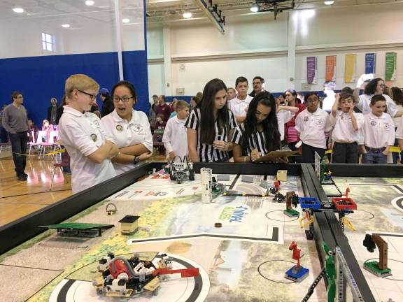 Student referees evaluating St. Therese Team &quot;Tornado Techs&quot; on robot performance
