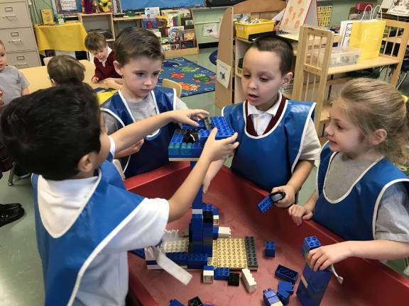 School offers Early Childhood Development Program From left, Reverend Brown pre-kindergarten students Adrian Acuria, Kellan O'Keeffe, John Joseh McCann and Angelina Braccioforte construct a tower out of Lego pieces during class recently. Acuria, O'Keeffe, McCann and Braccioforte are part of the Reverend Brown Early Childhood Development Program. Photo by Anthony Spaulding