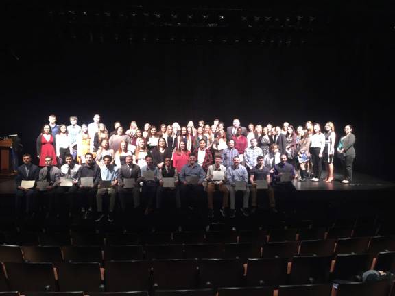 The Psi Beta inductees gather on the stage of the Performing Arts Center after the ceremony. Photo provided