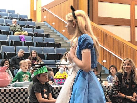 Photos: Mad Hatter’s Tea Party <b>The Sparta Middle School student playing Alice sings during the Mad Hatter’s Tea Party. </b>