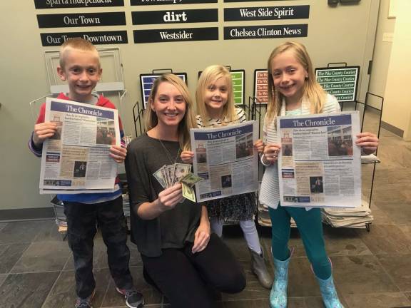 First Shop Local Sweepstakes winner announced Nicole Karchner with her children Savannah, Reagan, and Wyatt collecting her winnings for shopping at Bliss Boutique.